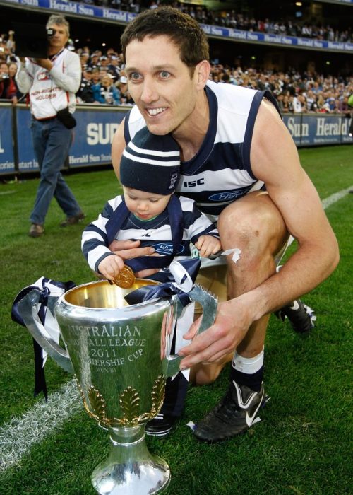 Geelong's Harry Taylor and his son enjoy their victory during the AFL 2011 Toyota Grand Final match between the Collingwood Magpies and the Geelong Cats at the MCG, Melbourne.